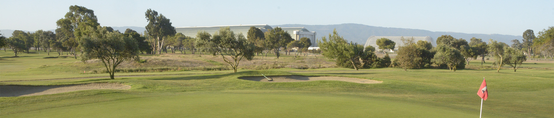 Image of golf ball on tee on grass.